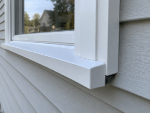 Professionally installed replacement window with exterior flashing details.