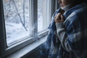 Cold draft coming through an old window during winter